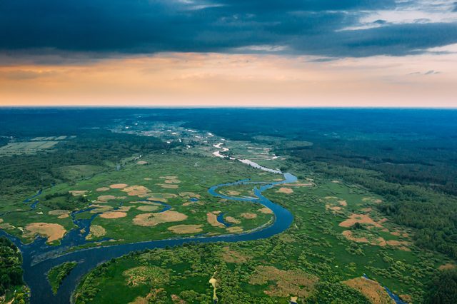 Sunset sky above green forest meadow in Mississippi representing divorce journey