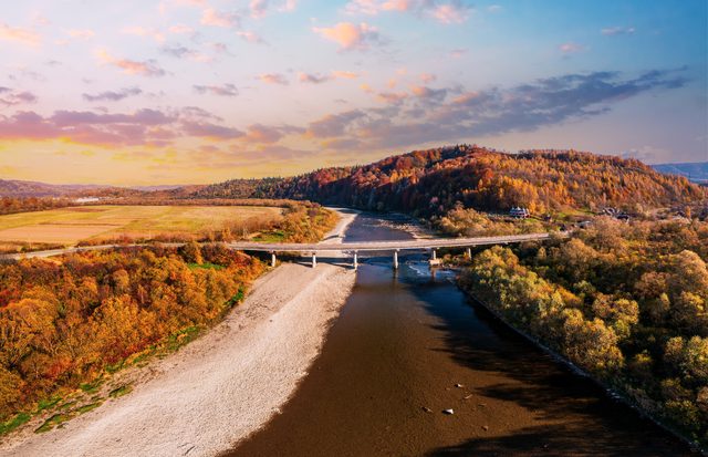 Scenic Missouri river bridge leading to a terracotta building, representing DIY divorce filing pathways