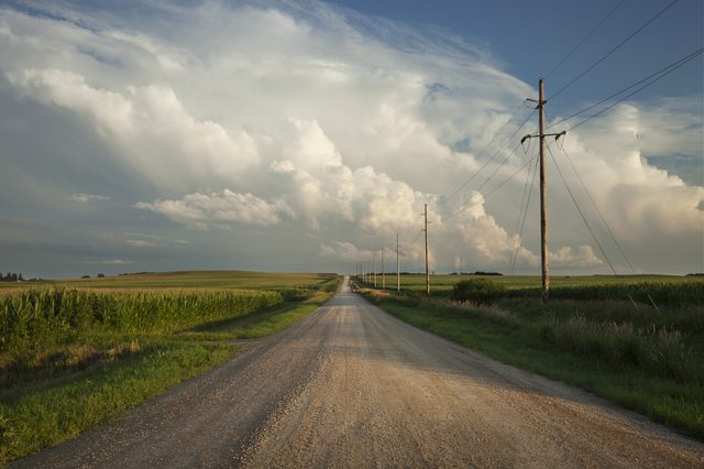 Nebraska rural road beneath dramatic clouds at sundown representing DIY divorce filing resources in Nebraska